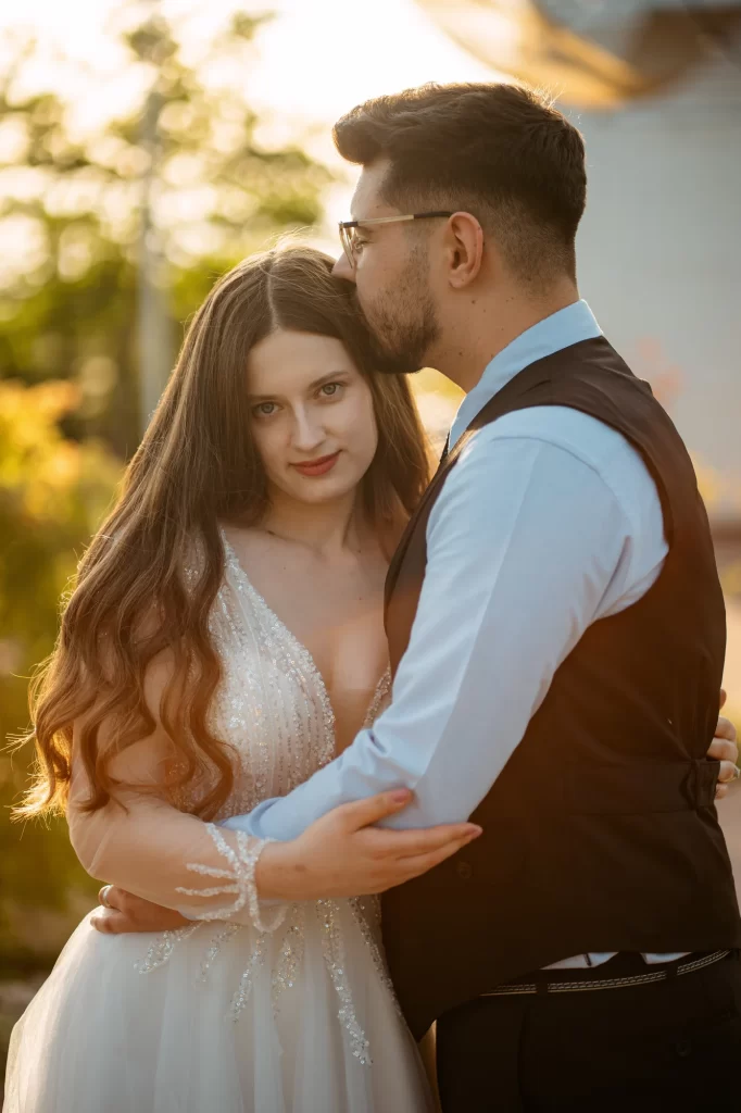 Mihaela & Mihai — Îmbrățișare la apus cu privirea miresei spre cameră.